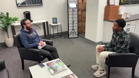 Rabbi being interviewed by fox6 employee about Chanukah festival