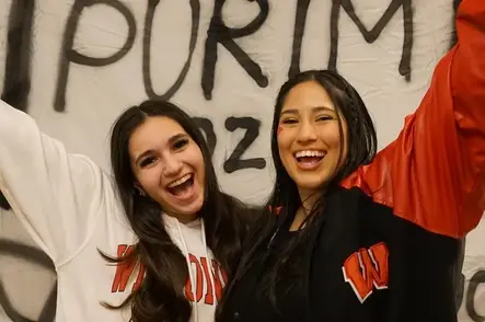 Two joyful women celebrating Purim on campus