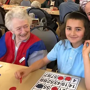 Boy playing bingo with senior