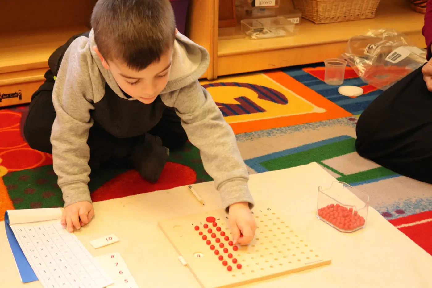 MATHEMATICS The child progresses from concrete to abstract through use of materials such as beads, spindle boxes and number rods.