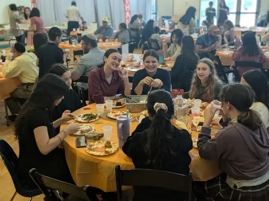 200 students, teachers, and family members enjoying Thanksgiving dinner last November.