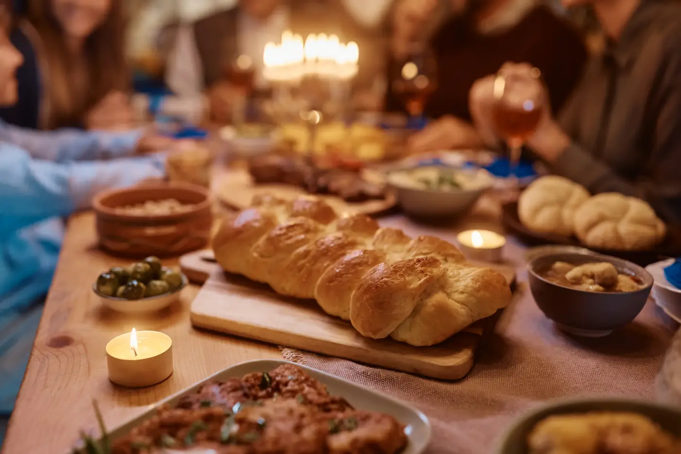 Traditional Challah bread during family dinner on Hanukkah.